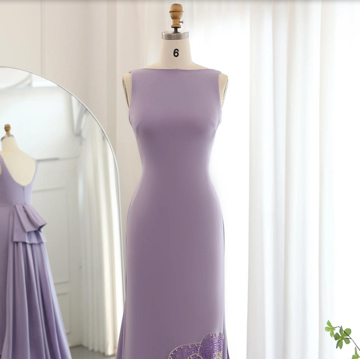 Sleeveless lavender jersey evening gown with intricate butterfly-inspired beadwork on a mannequin.