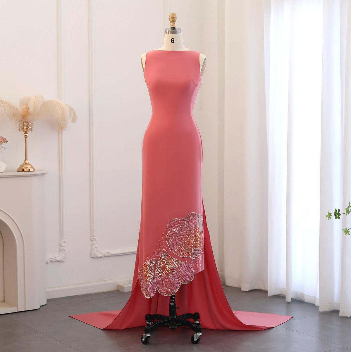 Sleeveless pink jersey evening gown featuring intricate butterfly-inspired sequin and crystal detailing on a floor-length train.