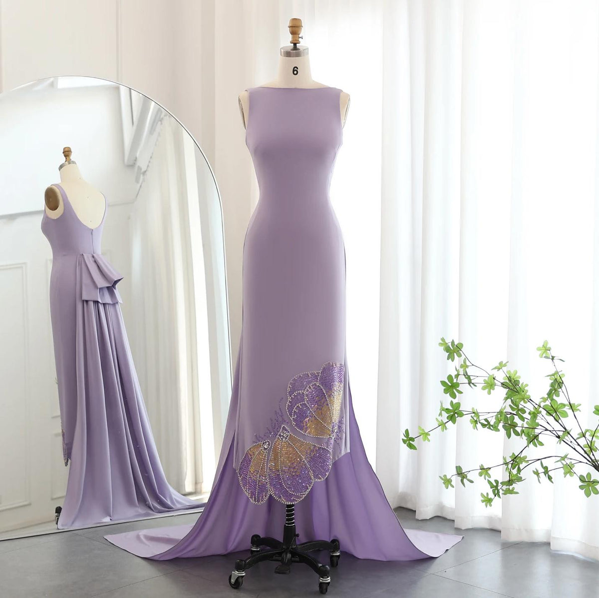 Lavender sleeveless jersey evening gown with butterfly-inspired sequin and crystal detailing on a dress form.