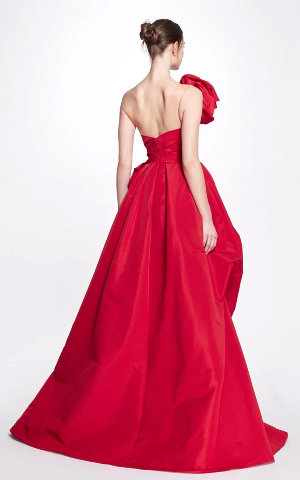 Red one-shoulder A-line gown in satin with a dramatic 3D floral accent and floor-length chapel train.