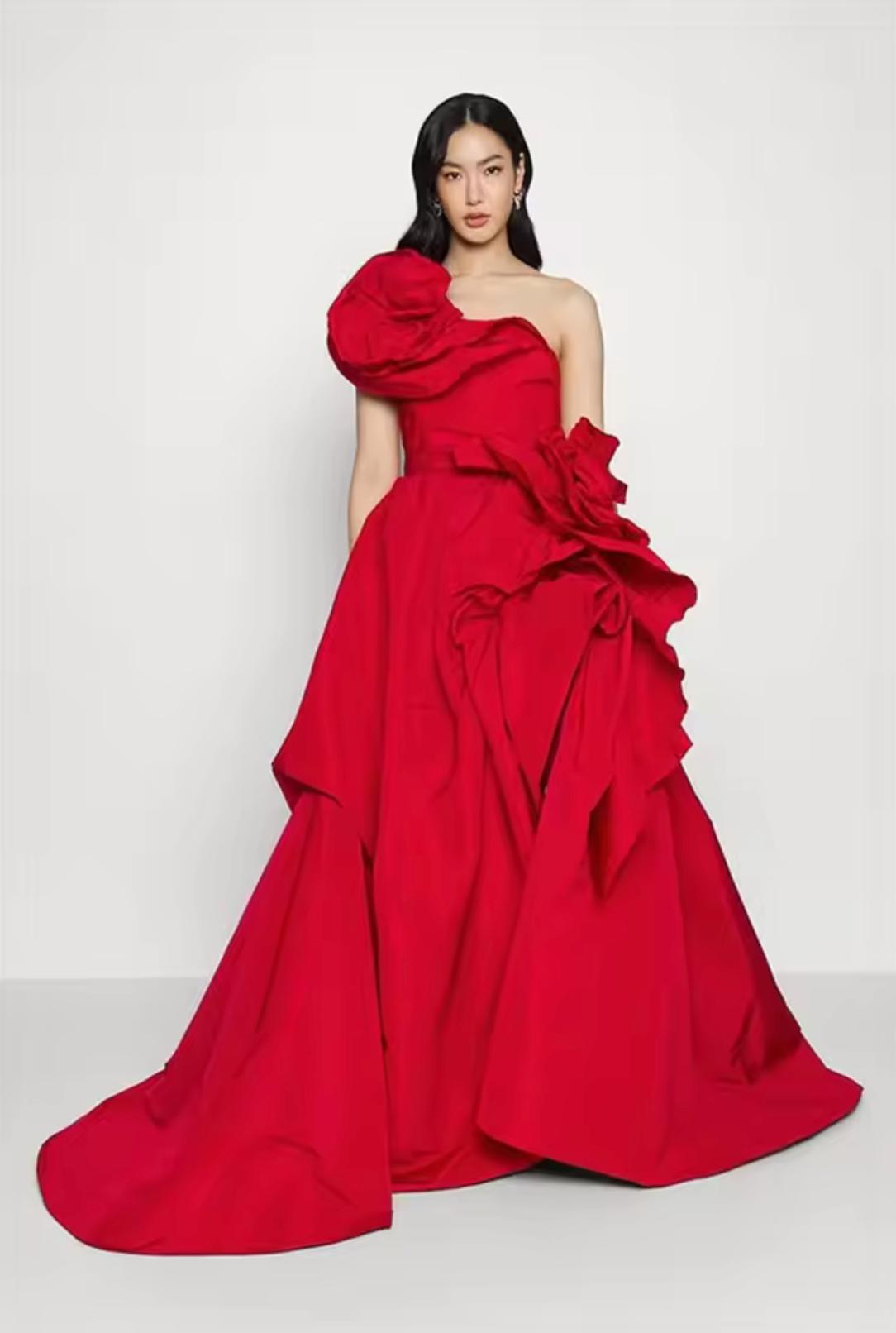 Red one-shoulder satin A-line gown featuring dramatic 3D oversized floral accents and a floor-length chapel train.