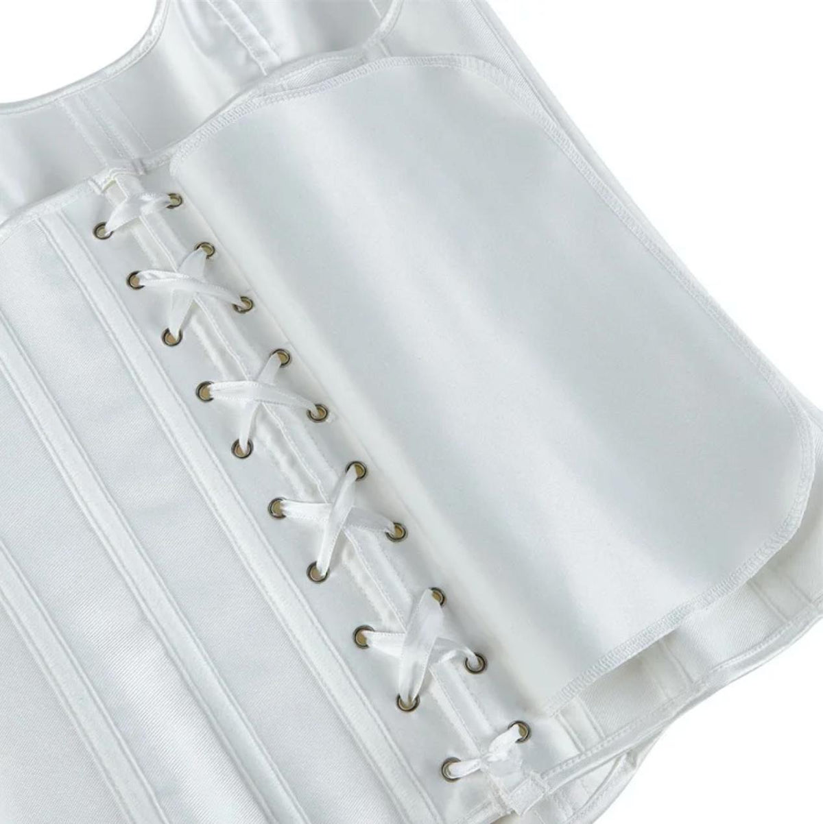 White satin corset bustier featuring structured boning, metal eyelets, and a delicate white ribbon lace-up back closure.