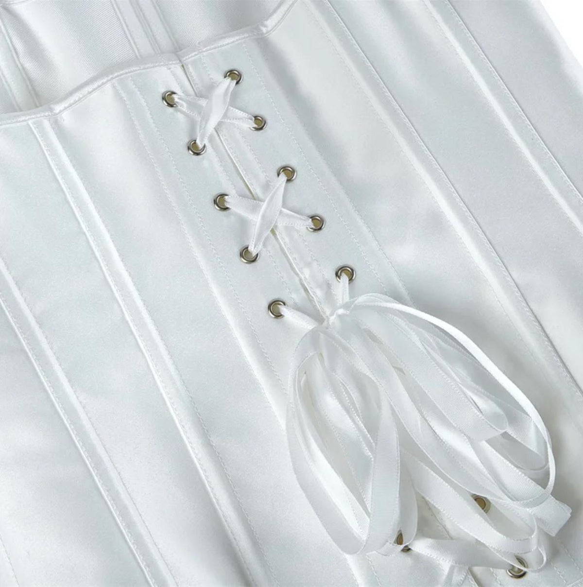 White satin overbust corset featuring structured boning and a decorative ribbon lace-up back with silver eyelets.