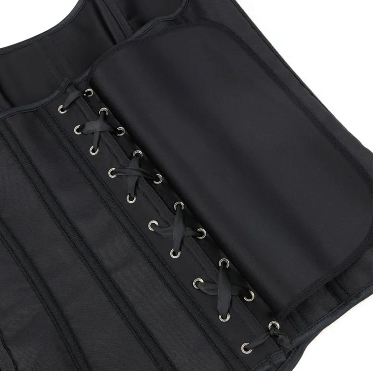 Black satin Soli corset featuring structured boning, silver eyelets, and a lace-up back design for a sculpted silhouette.