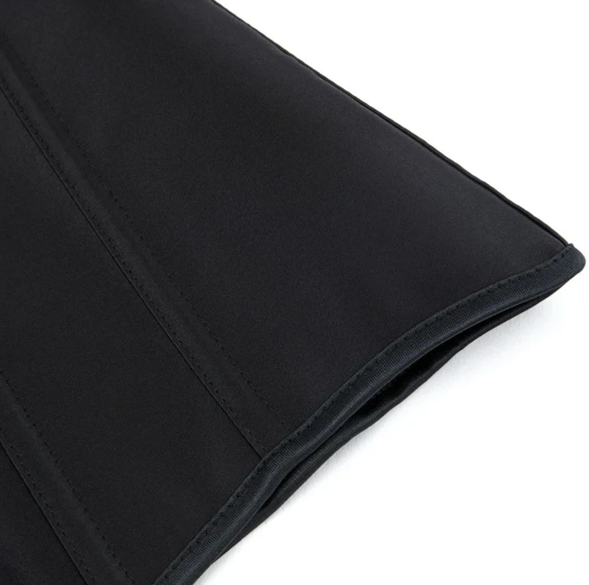 Close-up of a black satin Soli corset featuring structured boning and reinforced stitched seams.