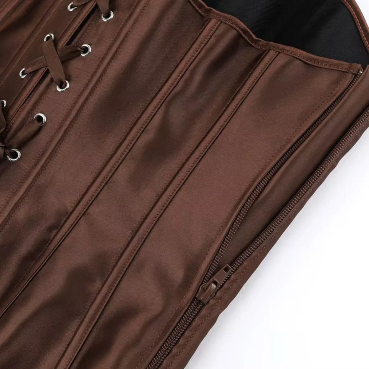 Brown satin Soli corset featuring structured boning, silver eyelet lace-up detail, and a convenient front zipper closure.