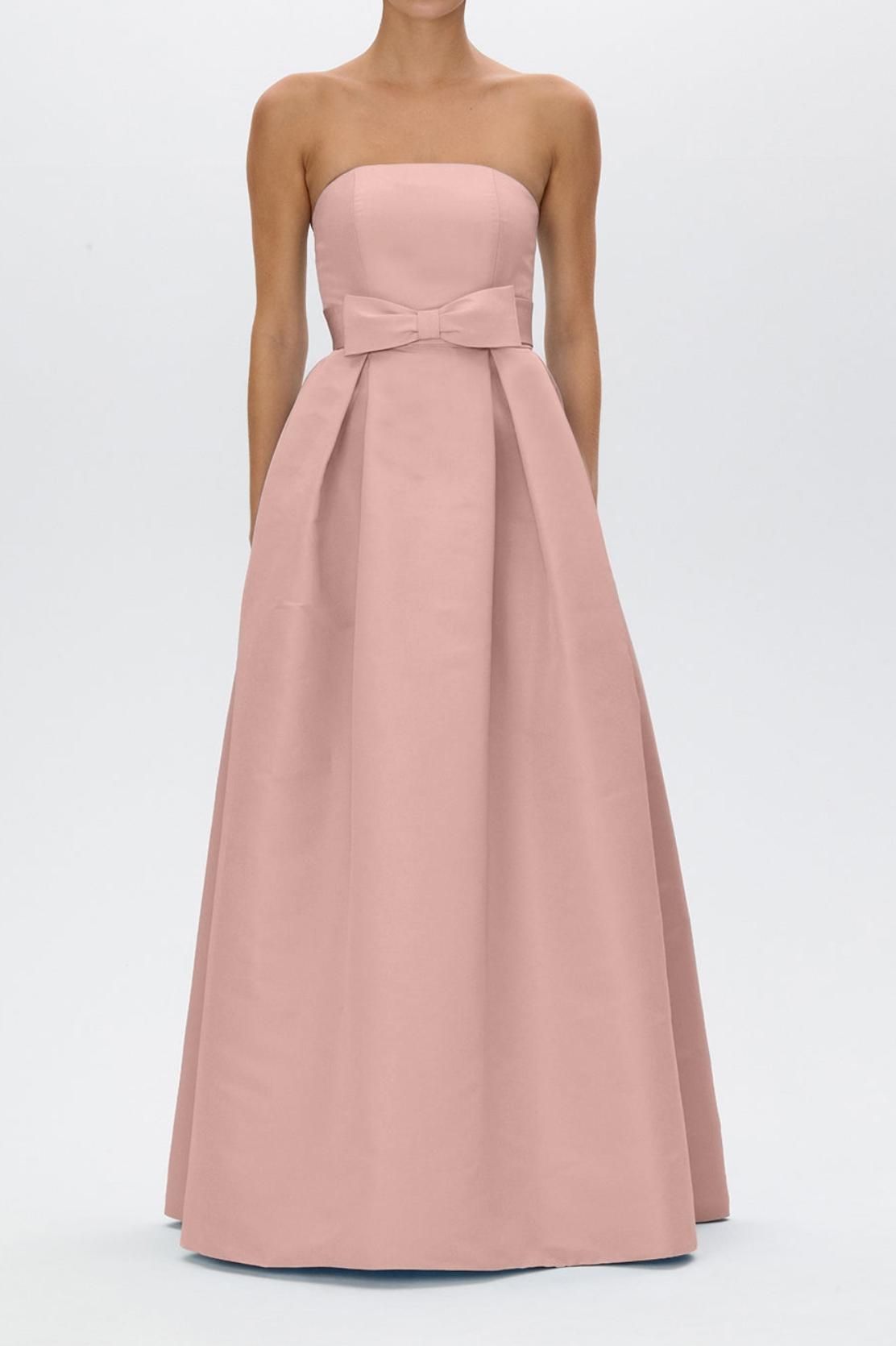 Strapless blush pink satin formal gown with a pleated full-length skirt and a removable bow belt at the natural waist.