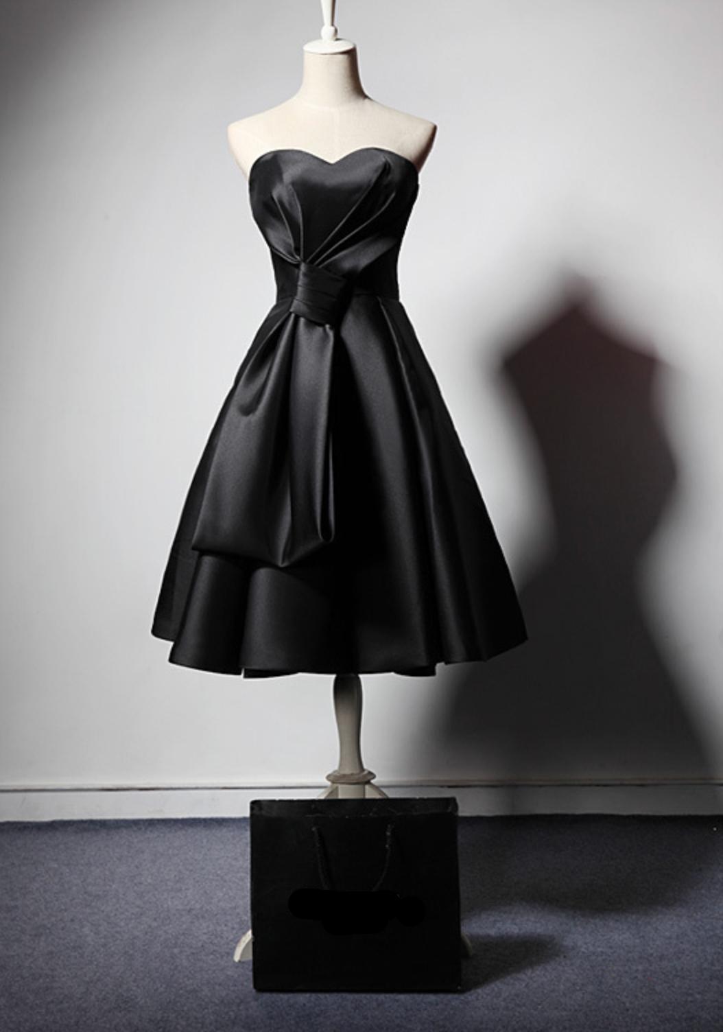 Black satin midi dress with a sweetheart neckline, pleated bodice, and flared skirt on a mannequin.