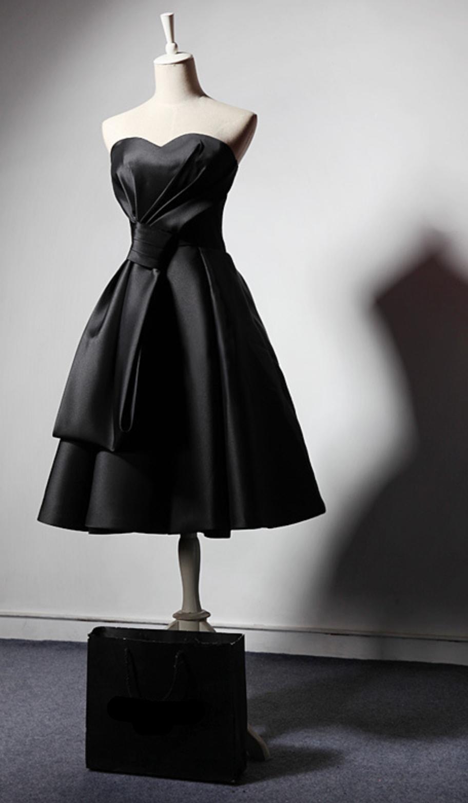 Sleeveless black satin midi dress with a sweetheart neckline and pleated A-line skirt on a mannequin.