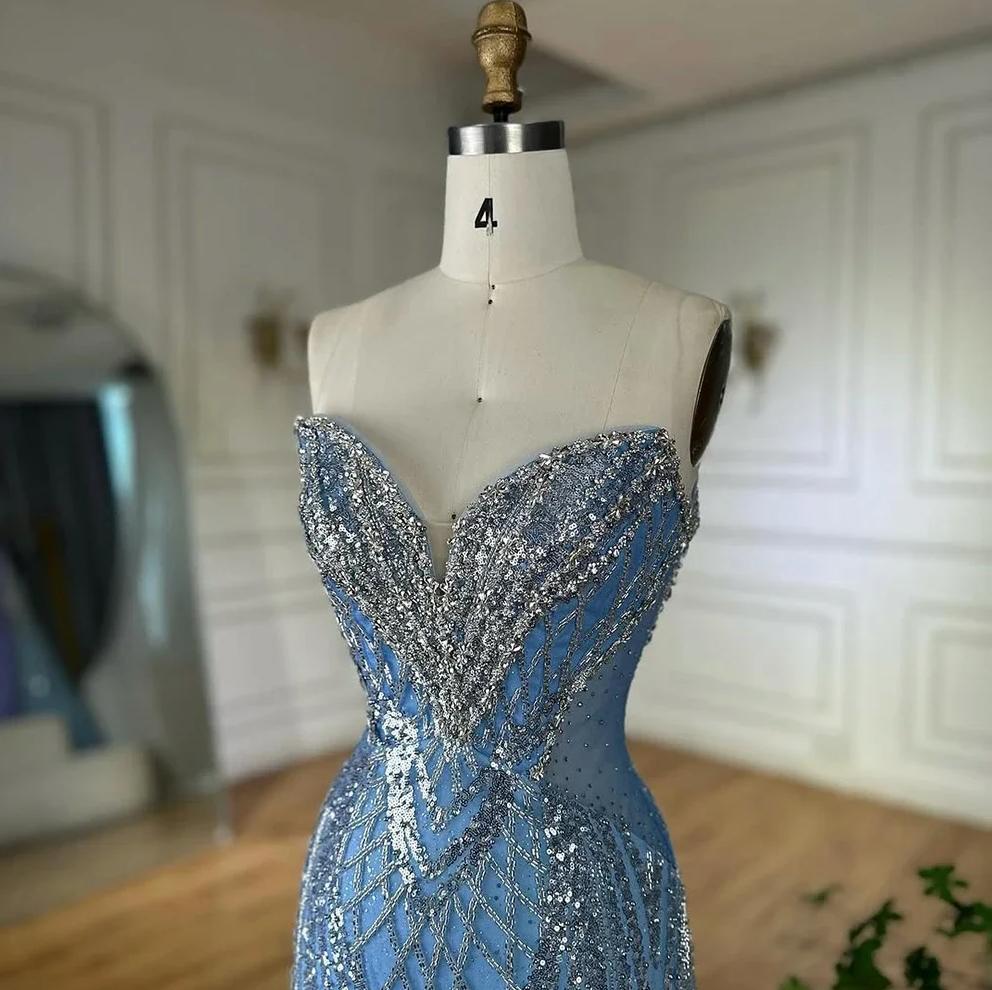 Strapless blue tulle mermaid gown featuring intricate silver sequin beadwork and a sweetheart neckline on a mannequin.