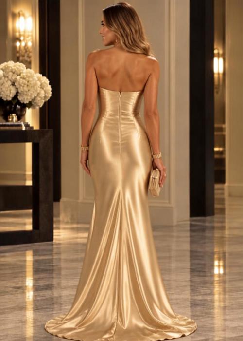 Back view of a gold satin strapless mermaid gown with a sweetheart neckline and a flowing sweep train.