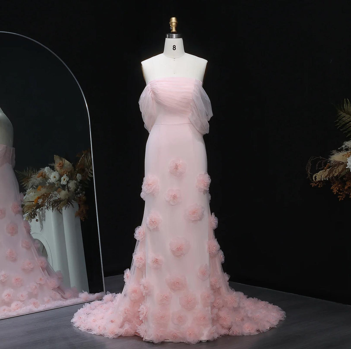 Daring pink off-shoulder mermaid evening gown in satin with delicate 3D floral accents and a floor-length train.
