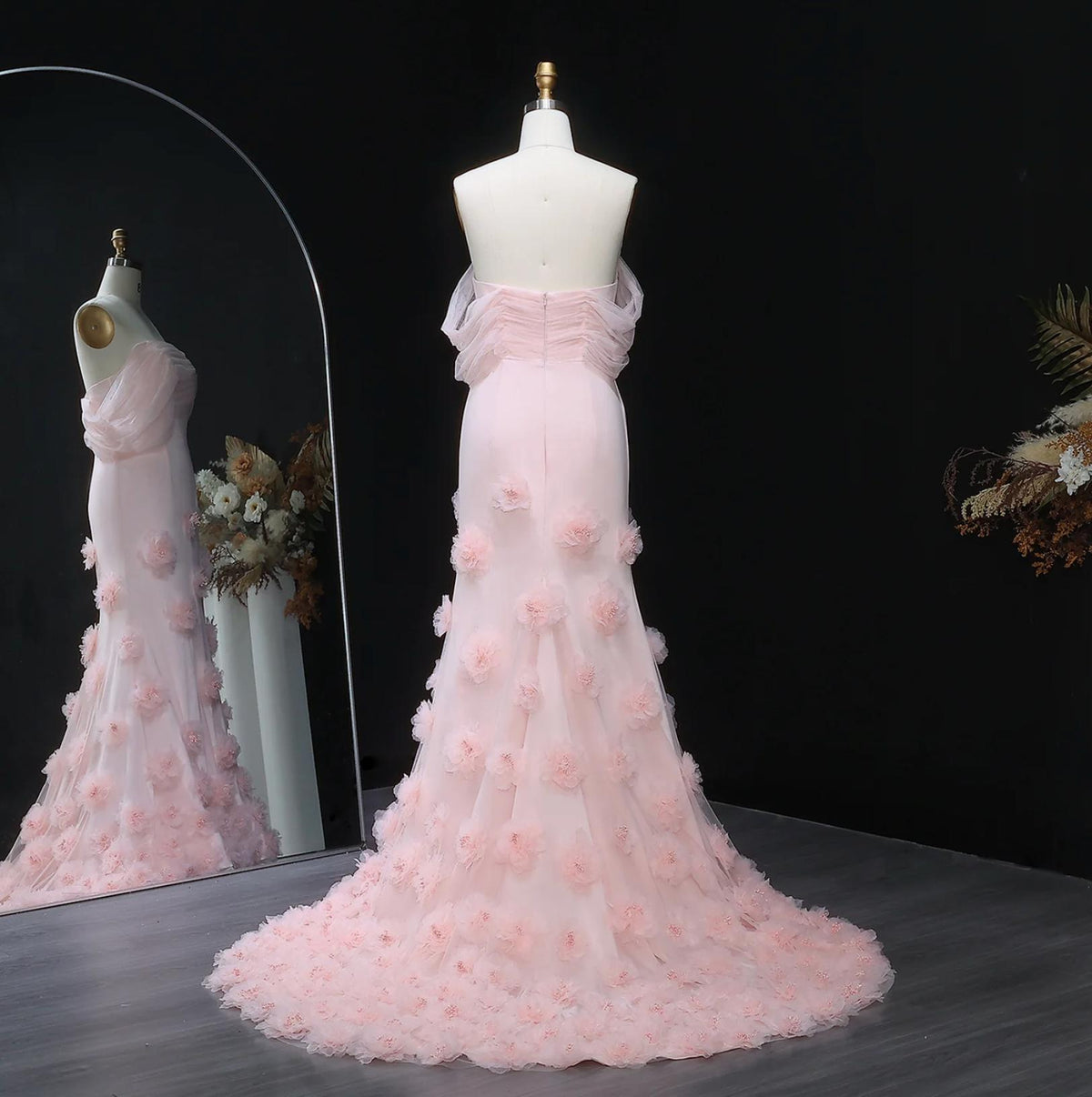 Daring pink off-shoulder mermaid evening gown in satin with delicate 3D floral accents and a floor-length train.