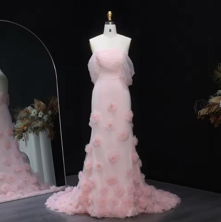 Daring pink off-shoulder satin mermaid gown featuring delicate 3D floral accents and a floor-length silhouette on a mannequin.