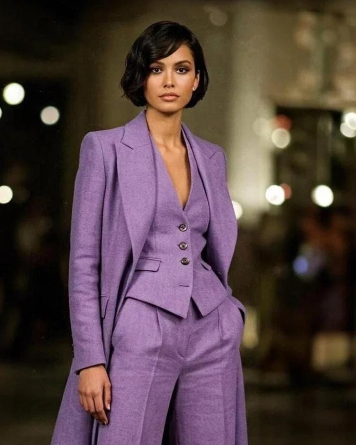Woman wearing a purple linen three-piece suit with a V-neck vest, single-button blazer, and wide-leg trousers.