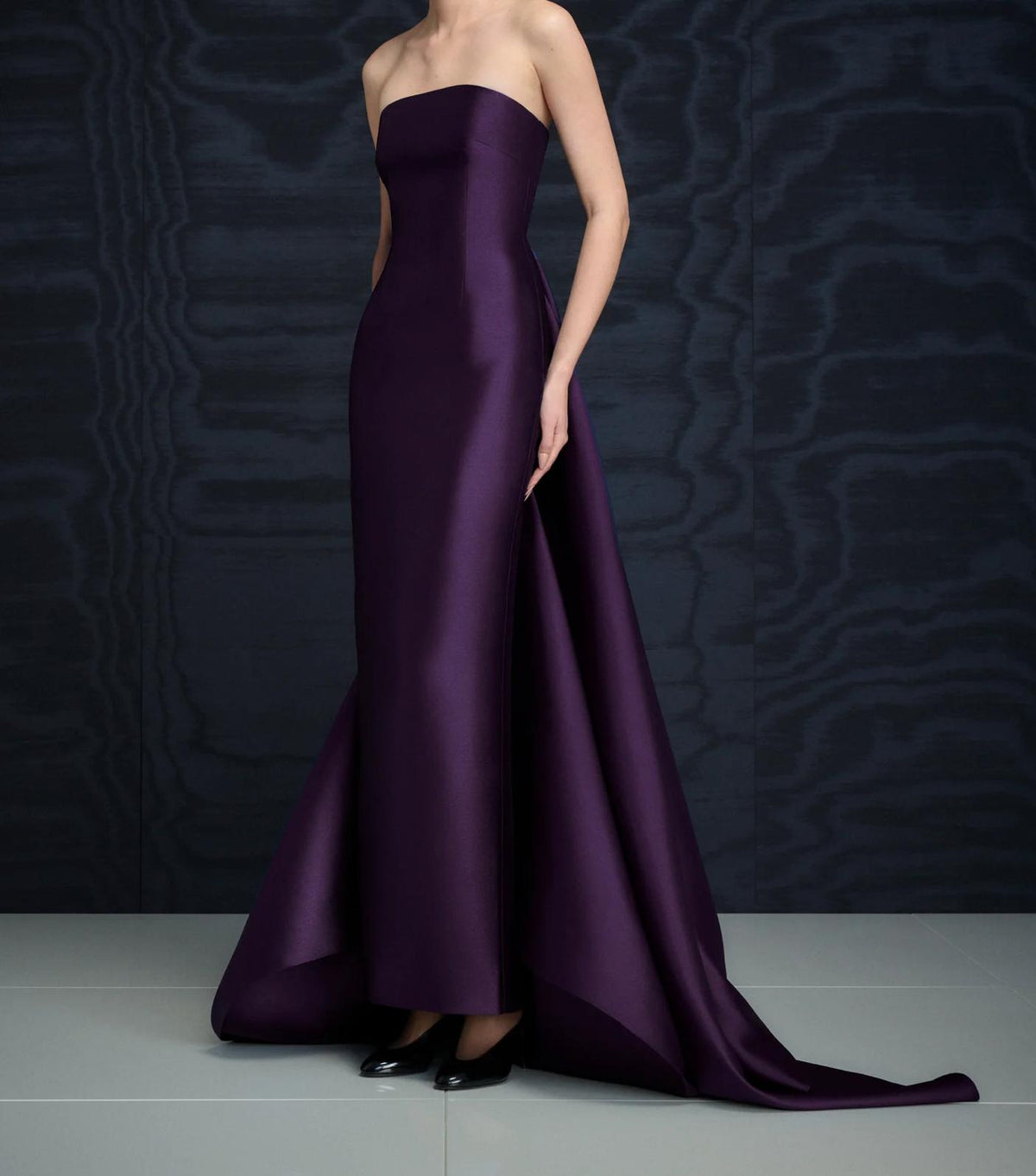 Strapless deep purple satin floor-length gown with a dramatic detachable train and structured silhouette.