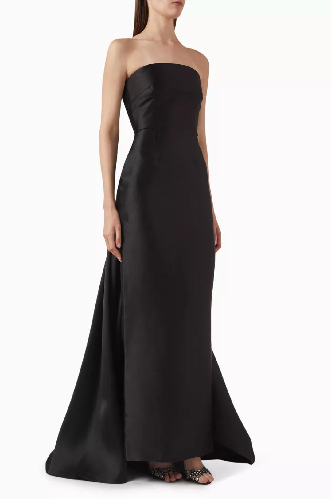 Strapless black satin floor-length gown with a detachable train and structured silhouette.