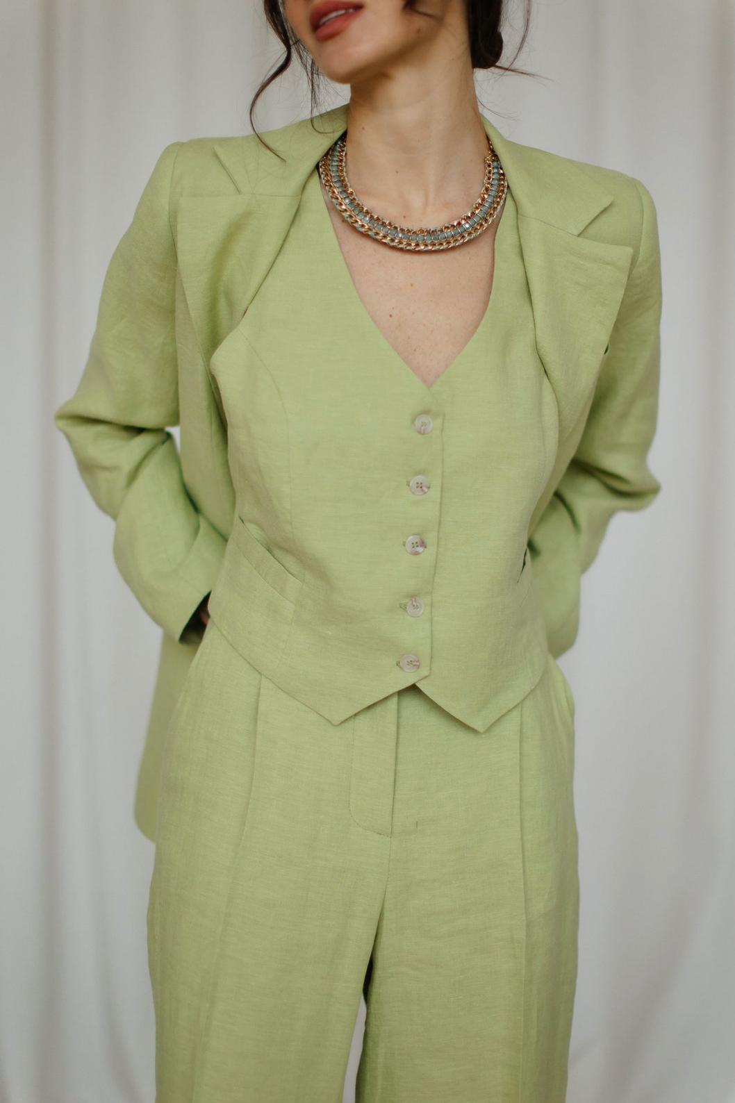 Light green three-piece linen suit featuring a tailored jacket, button-down vest, and matching palazzo trousers.