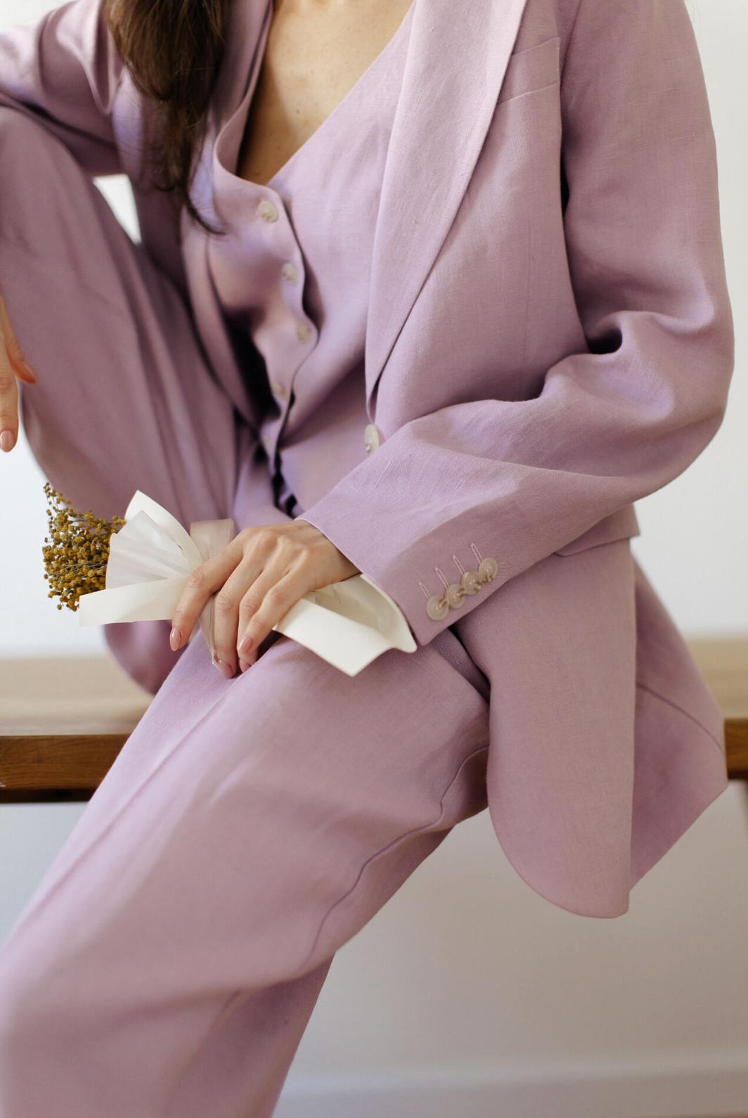 Lavender linen three-piece suit featuring a tailored jacket, buttoned vest, and matching palazzo pants.