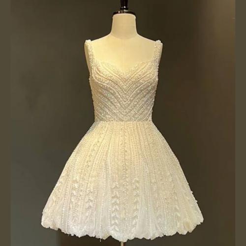 Champagne tulle mini dress with heavy beadwork, crystals, sequins, a scoop neckline, and a flattering empire waist.