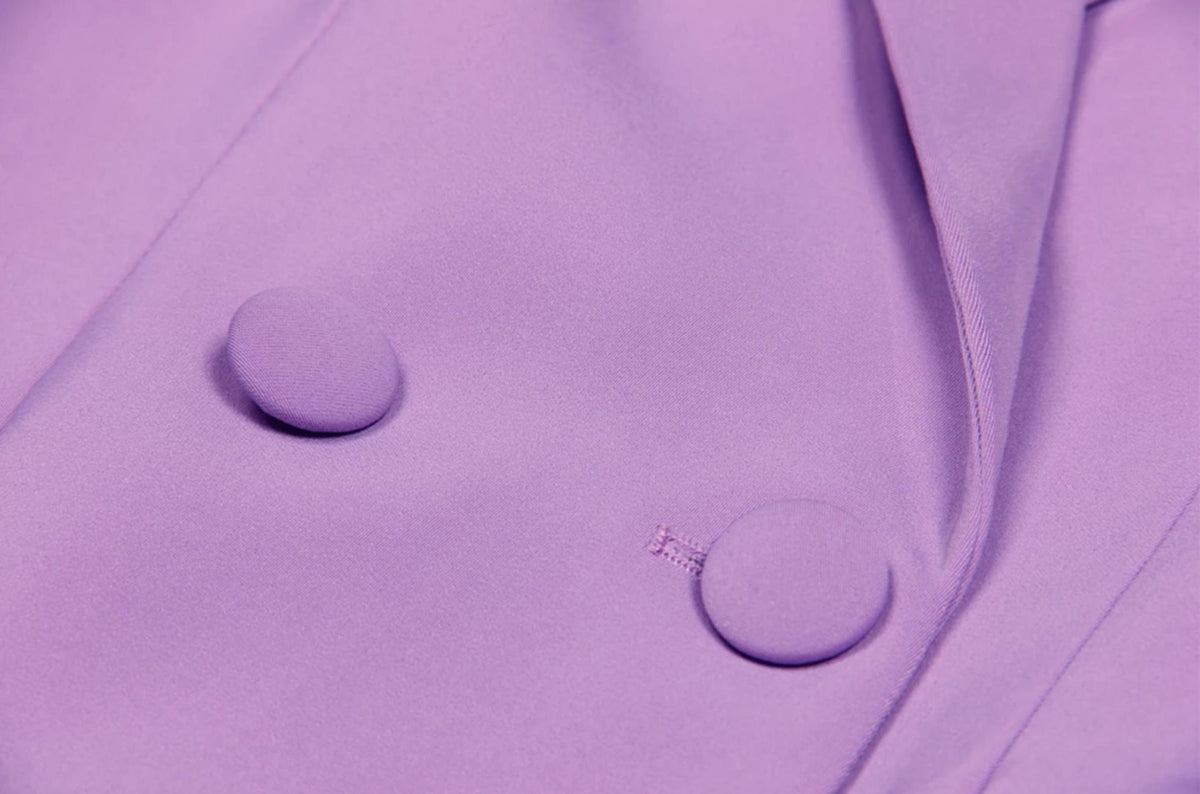 Close-up of a lavender Italian satin double-breasted suit jacket featuring matching fabric-covered buttons.