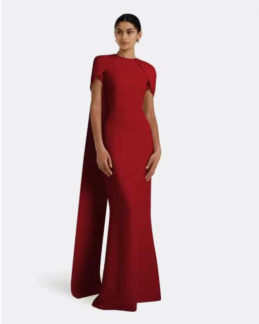 Model wearing a floor-length red satin A-line gown with an O-neck and elegant cape-style sleeves.