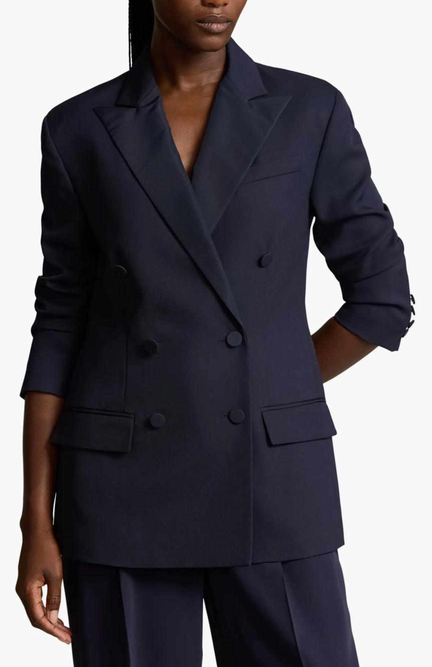 Navy blue double-breasted cotton twill blazer with peak lapels and matching tailored trousers.