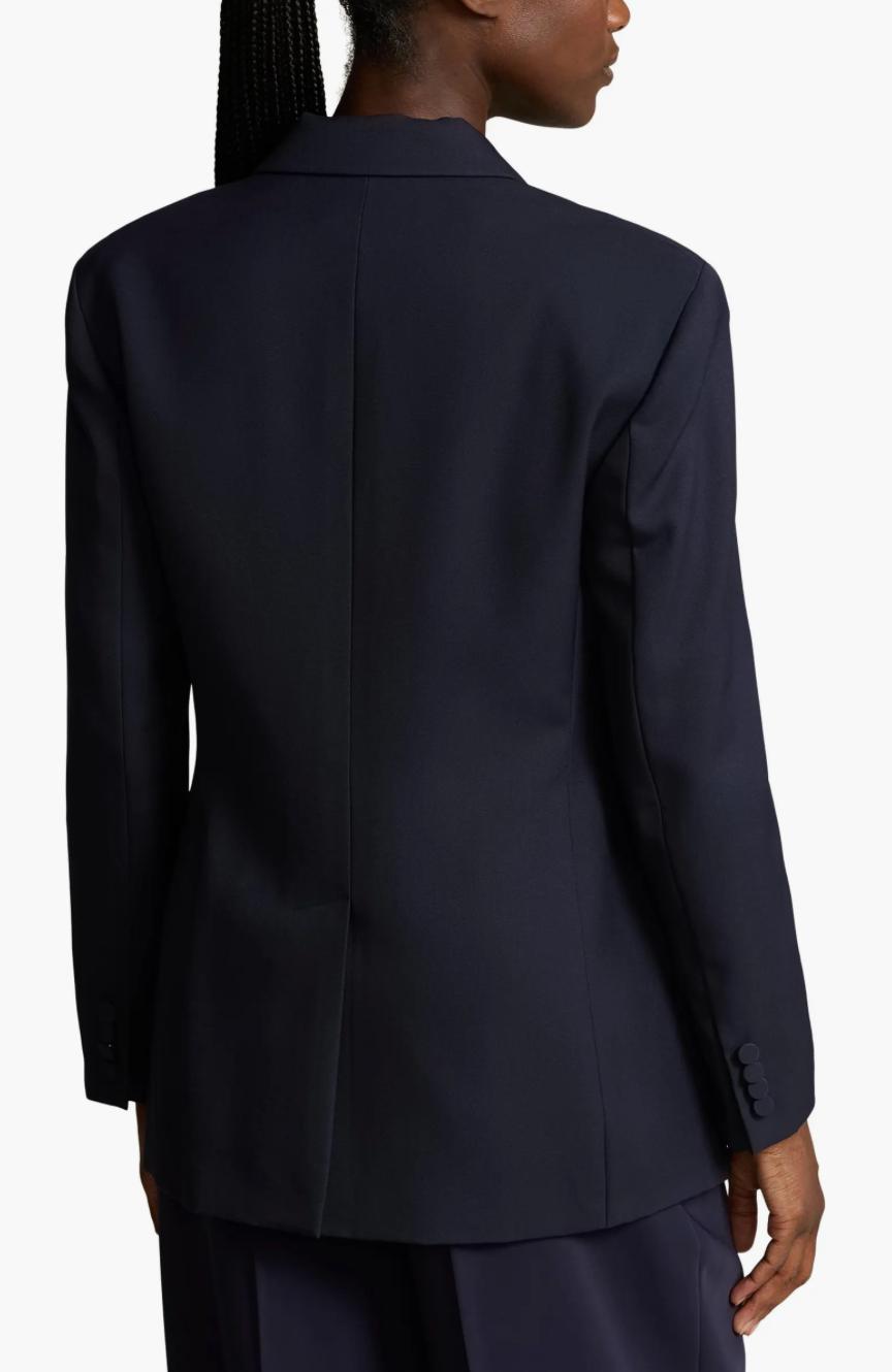 Back view of a navy blue cotton twill two-piece suit featuring a tailored blazer with a center back vent.