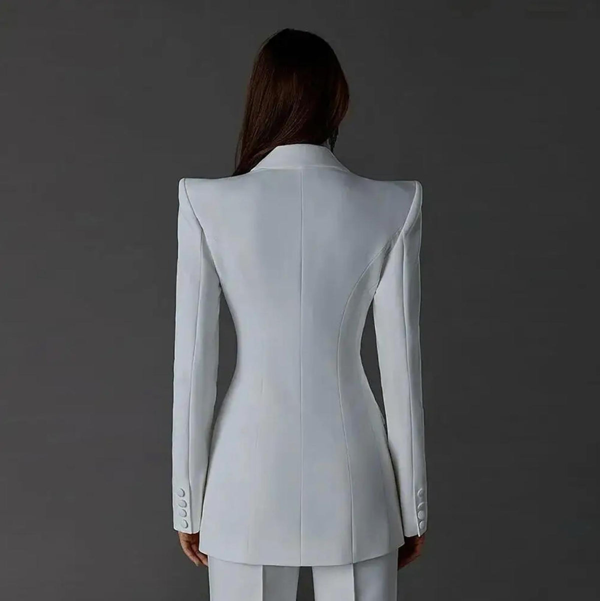 Back view of a white Via Condotti suit set featuring a sharp, tailored blazer with structured shoulders and satin details.