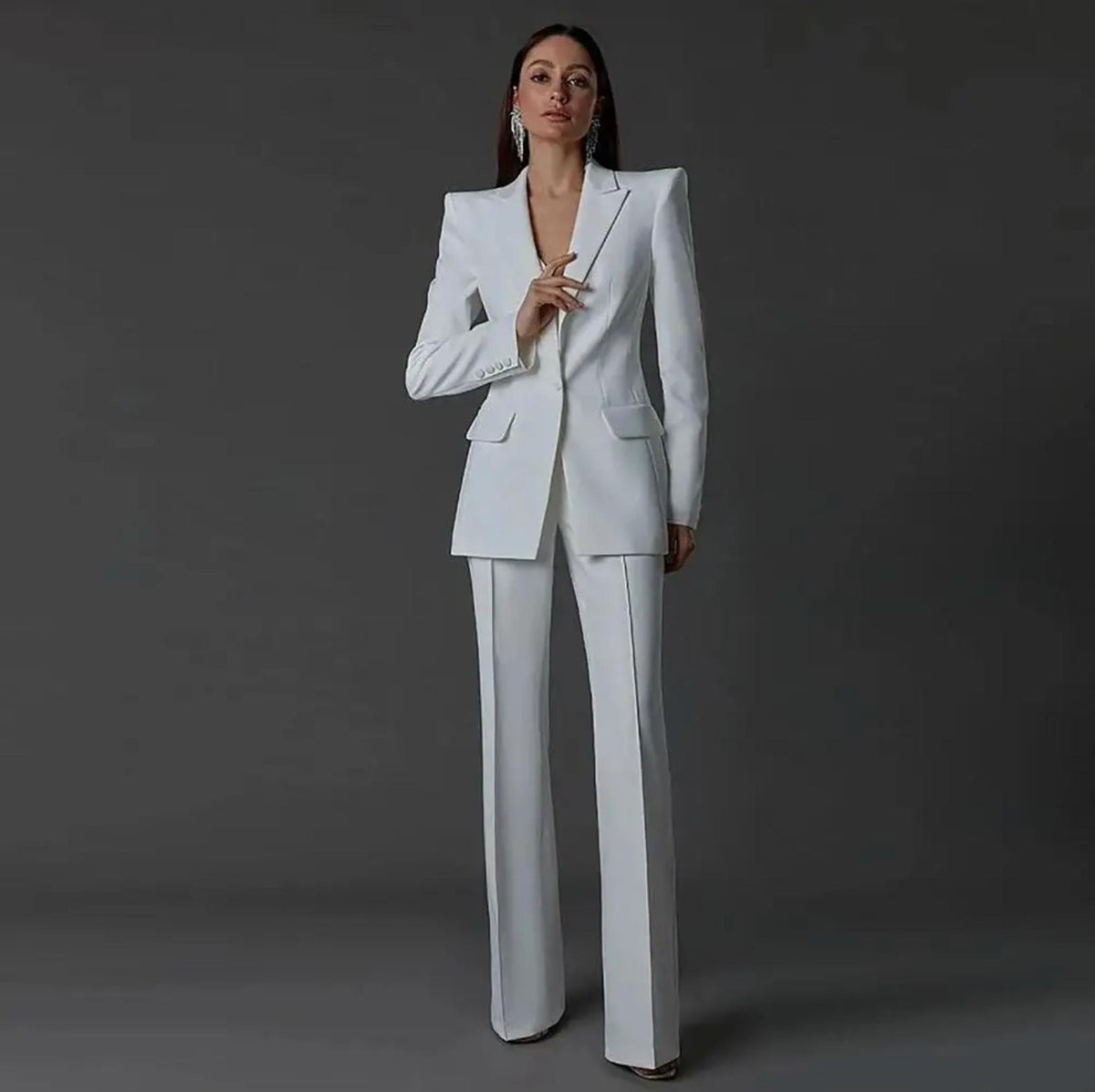 Woman wearing a sharp, white single-breasted Via Condotti suit set with tailored trousers and structured blazer shoulders.