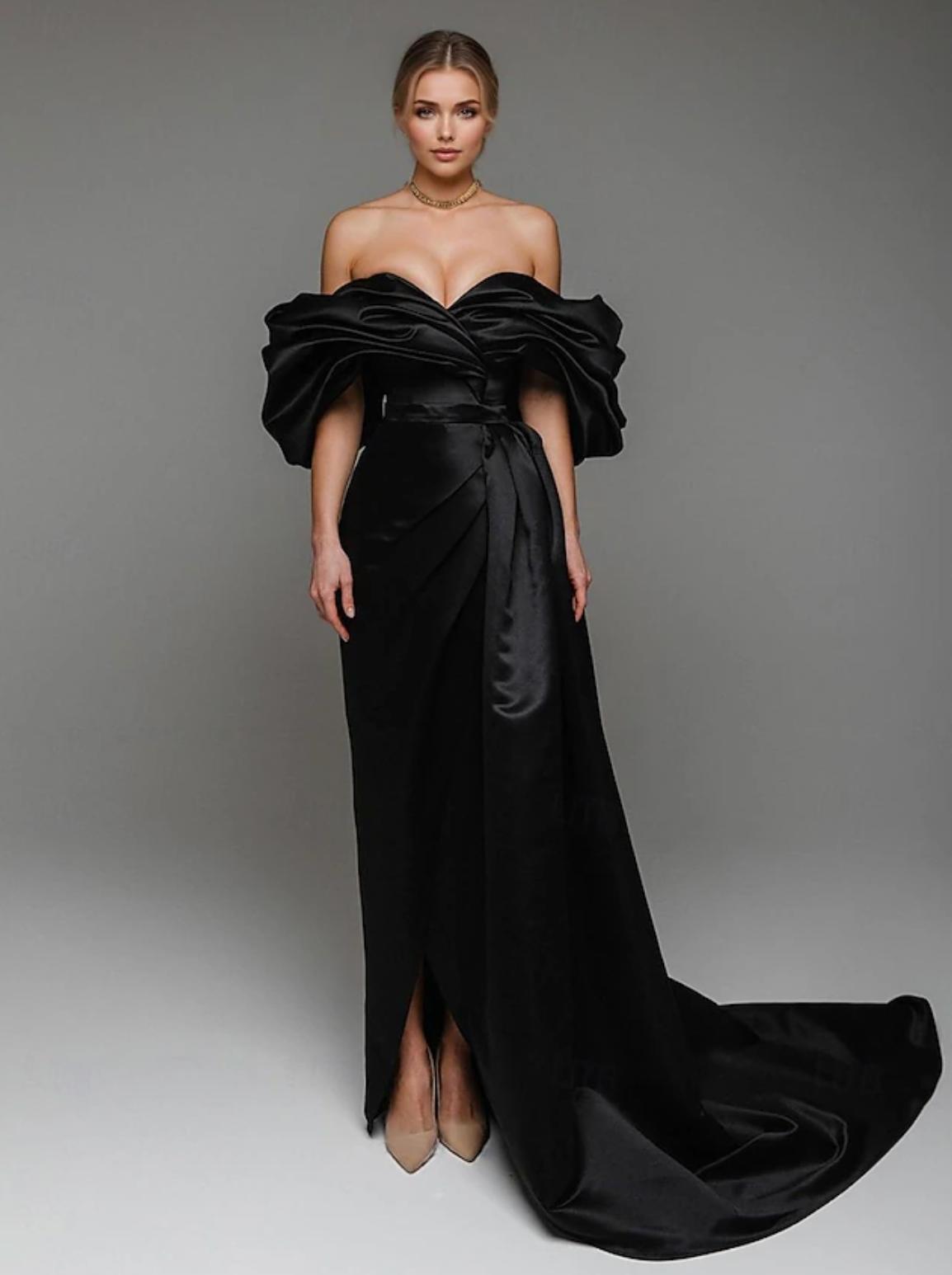 Model wearing a floor-length black satin Viceroy Bali gown with an off-shoulder pleated corset bodice and train.