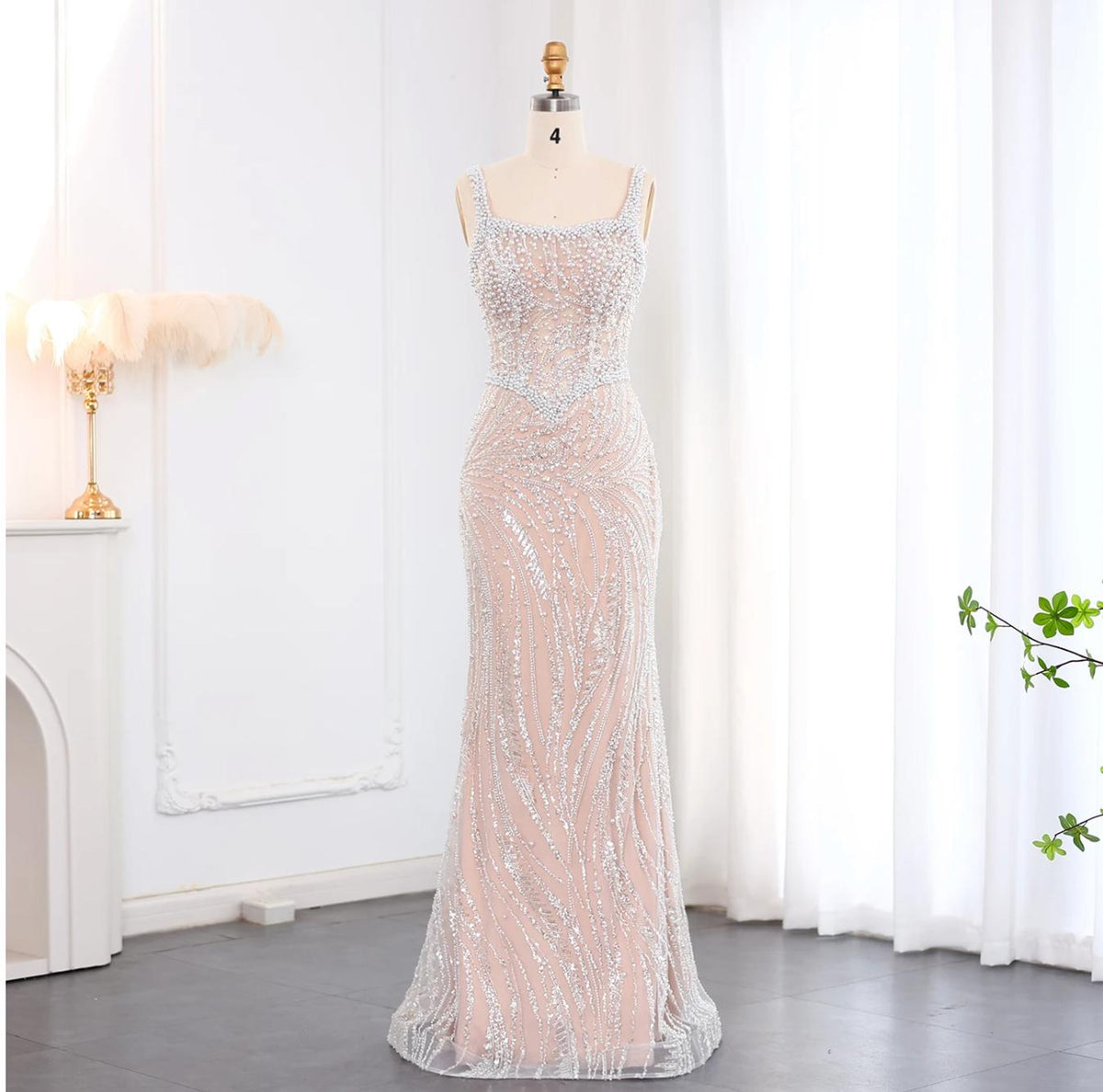 Floor-length Wailiku gown in soft tulle with a square neckline, spaghetti straps, and intricate pearl and crystal beading.