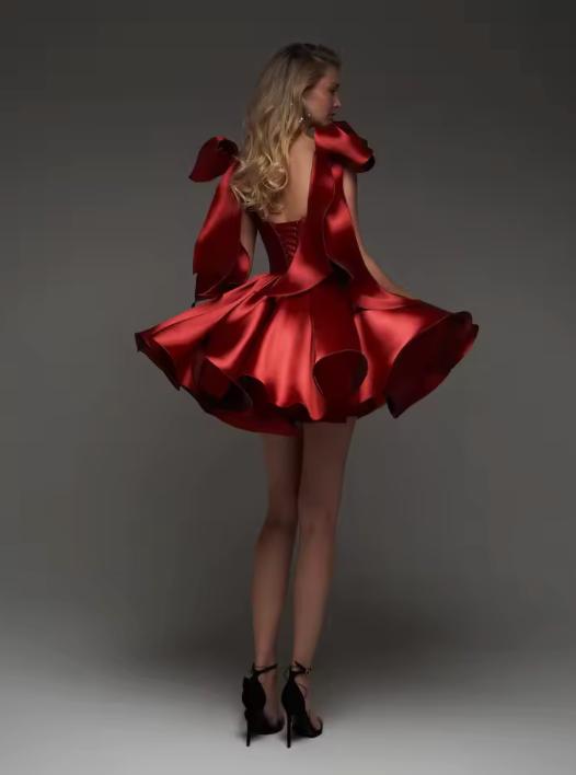 Red satin mini dress with a flared skirt, sweetheart neckline, oversized shoulder bows, and a lace-up back closure.