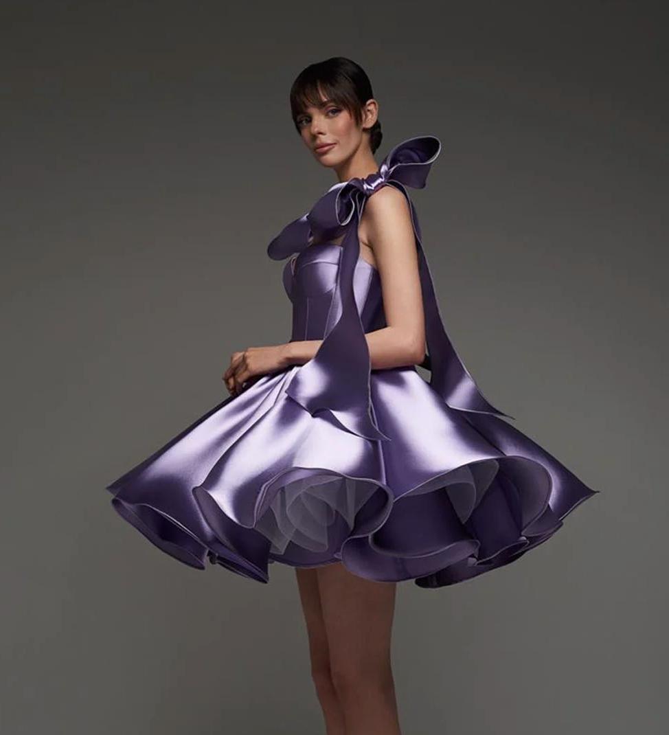 Purple satin mini ball gown with a sweetheart neckline, empire waist, and large decorative shoulder bows.