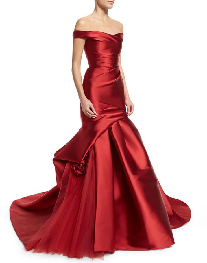 Red satin off-shoulder mermaid evening gown with draped bodice, 3D floral accents, and a flared tulle-lined skirt.