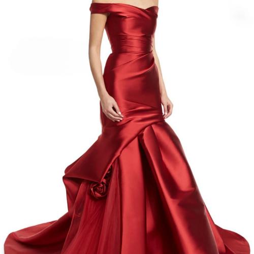 Red satin off-shoulder mermaid evening gown with elegant draping and 3D floral accents.
