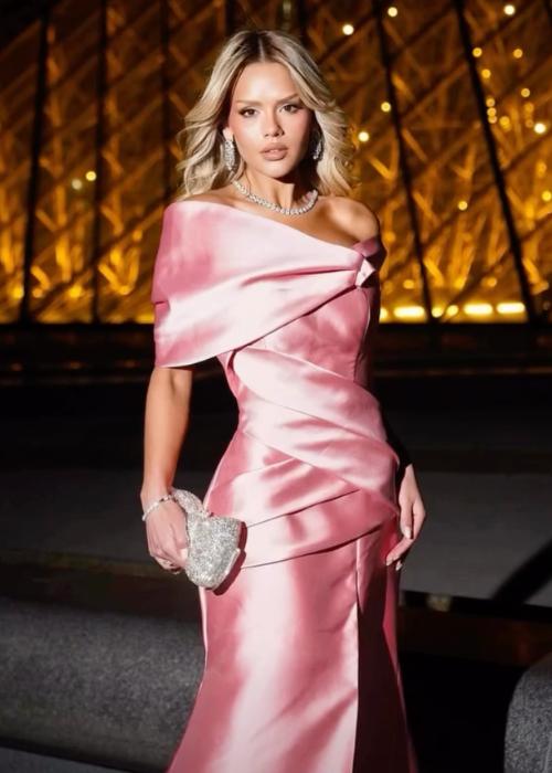 Elegant pink satin off-shoulder mermaid evening gown with structured pleated bodice and sophisticated silhouette.