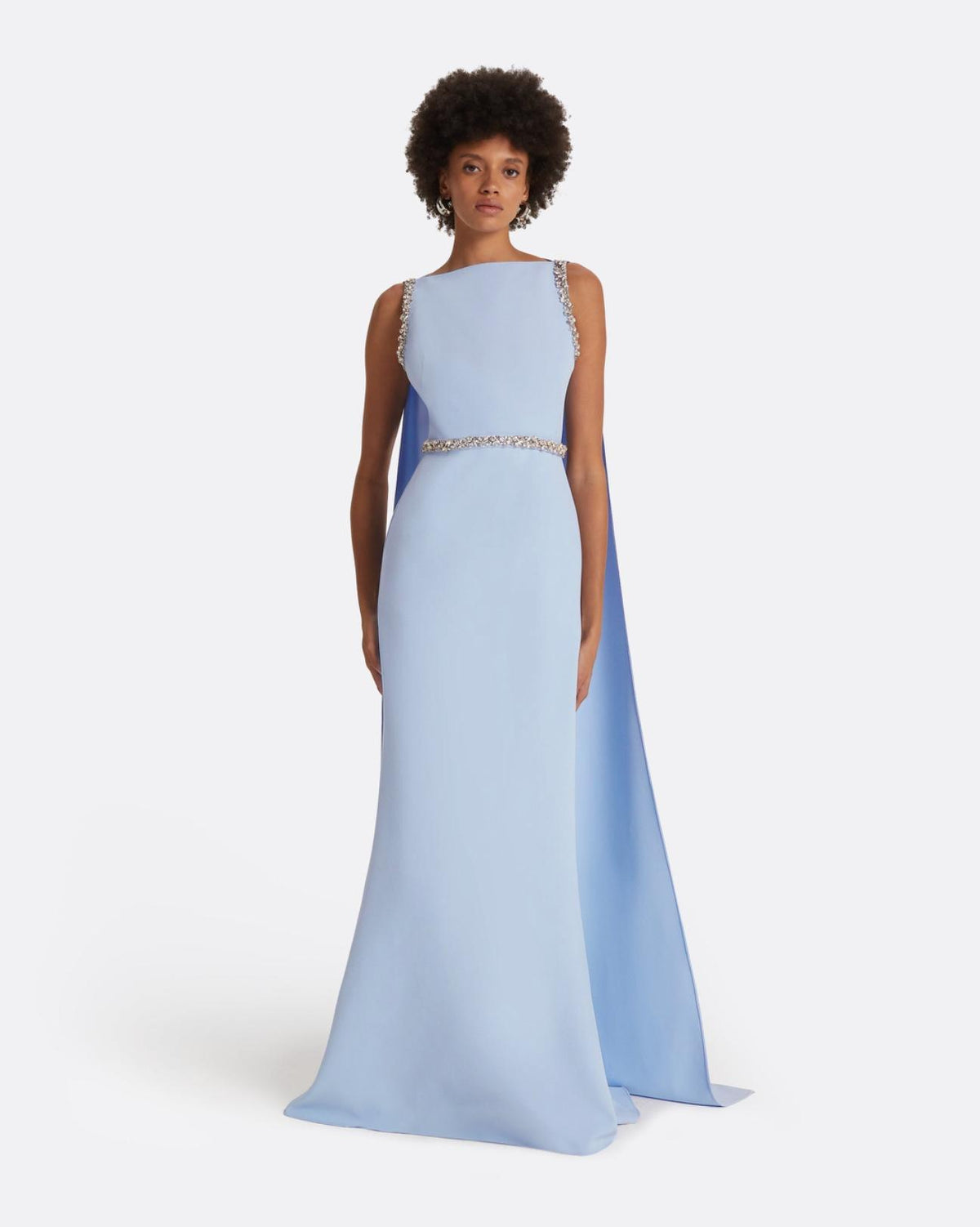 Light blue floor-length crepe gown with a dramatic split cape and intricate multi-pastel crystal detailing.