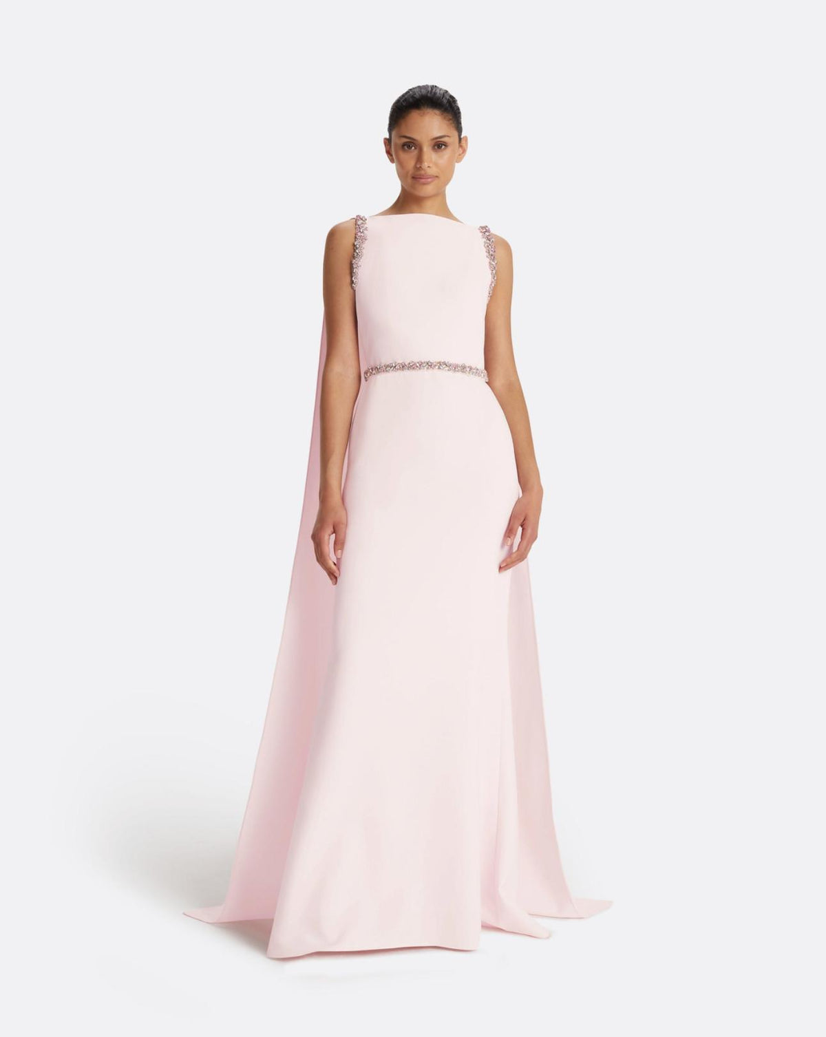 Pale pink floor-length crepe gown with a dramatic split cape and intricate multi-pastel crystal shoulder and waist detailing.