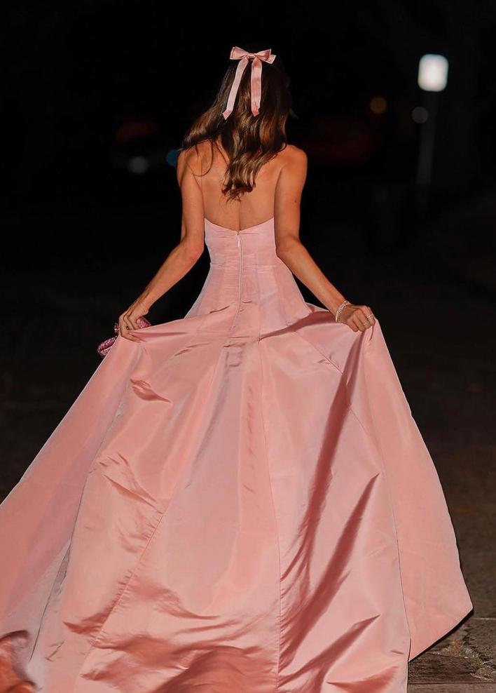 Strapless pink taffeta A-line gown with a fitted bodice, zipper back, and flowing skirt for formal occasions.