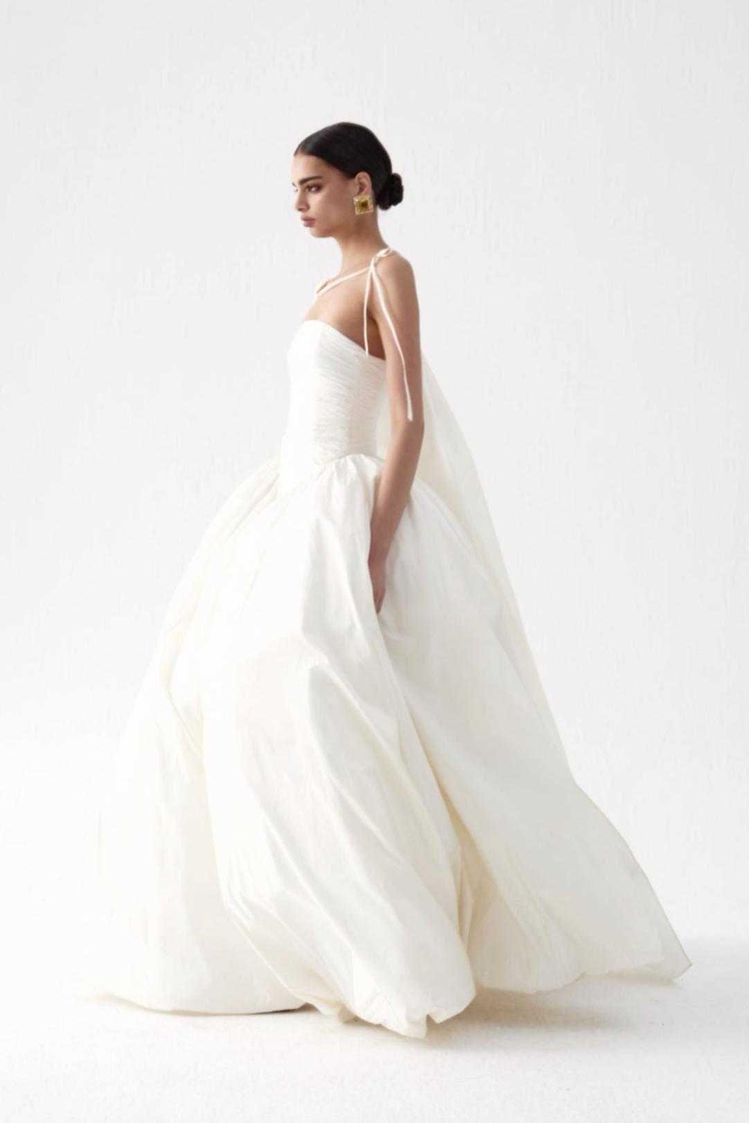 Strapless pink taffeta A-line gown with a fitted ruched bodice and flowing skirt, perfect for formal occasions.