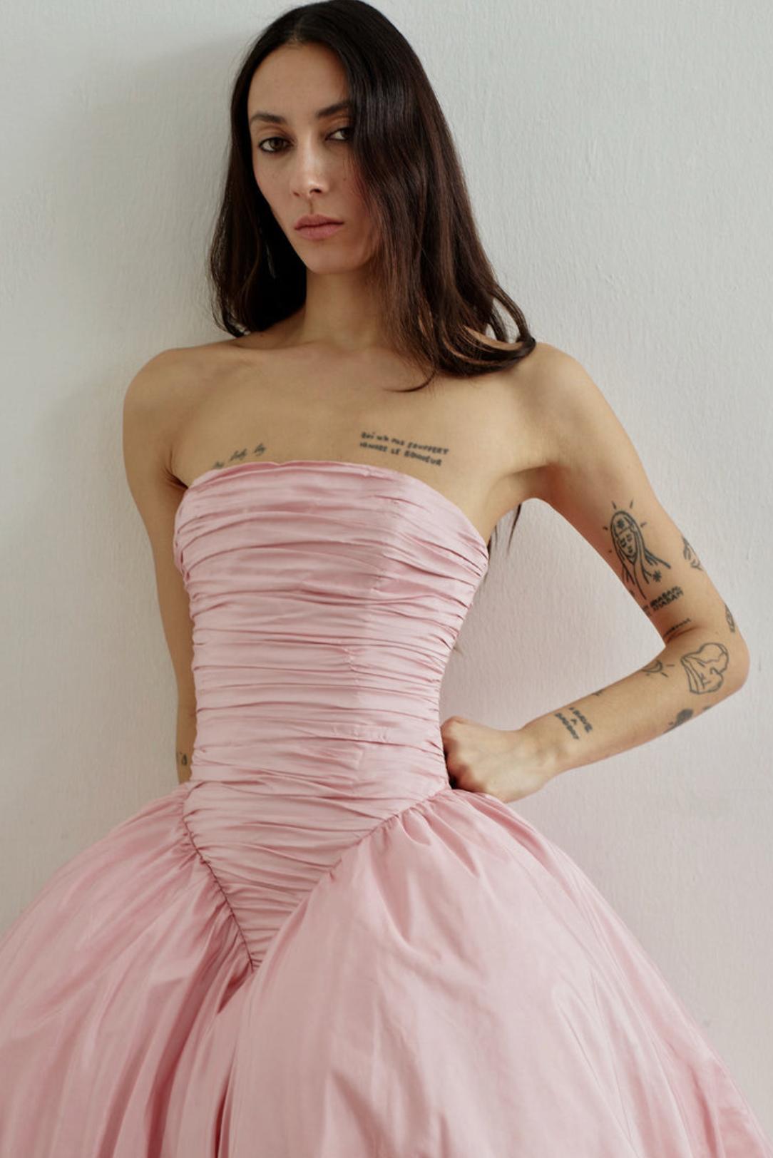 Strapless pink taffeta A-line gown with a fitted, ruched bodice and voluminous skirt for formal occasions.